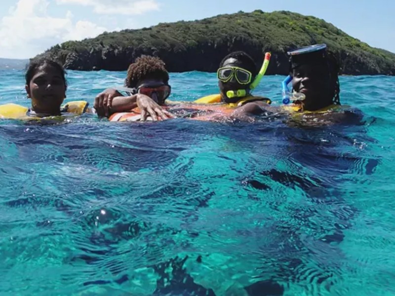 a child swimming in a body of water