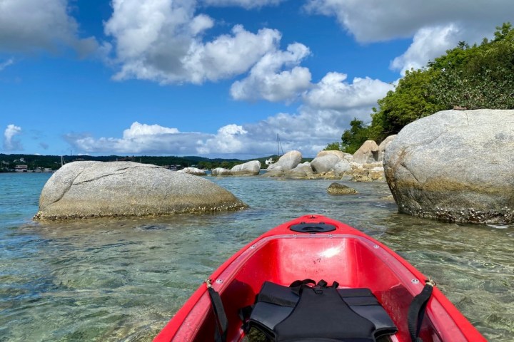 a person sitting next to a body of water