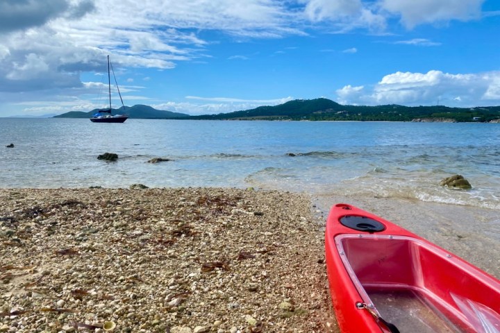 a boat sitting on top of a sandy beach